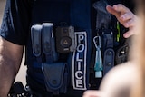 A police officer's torso showing a body cam