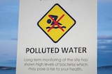Sign warning of polluted water at a suburban beach.